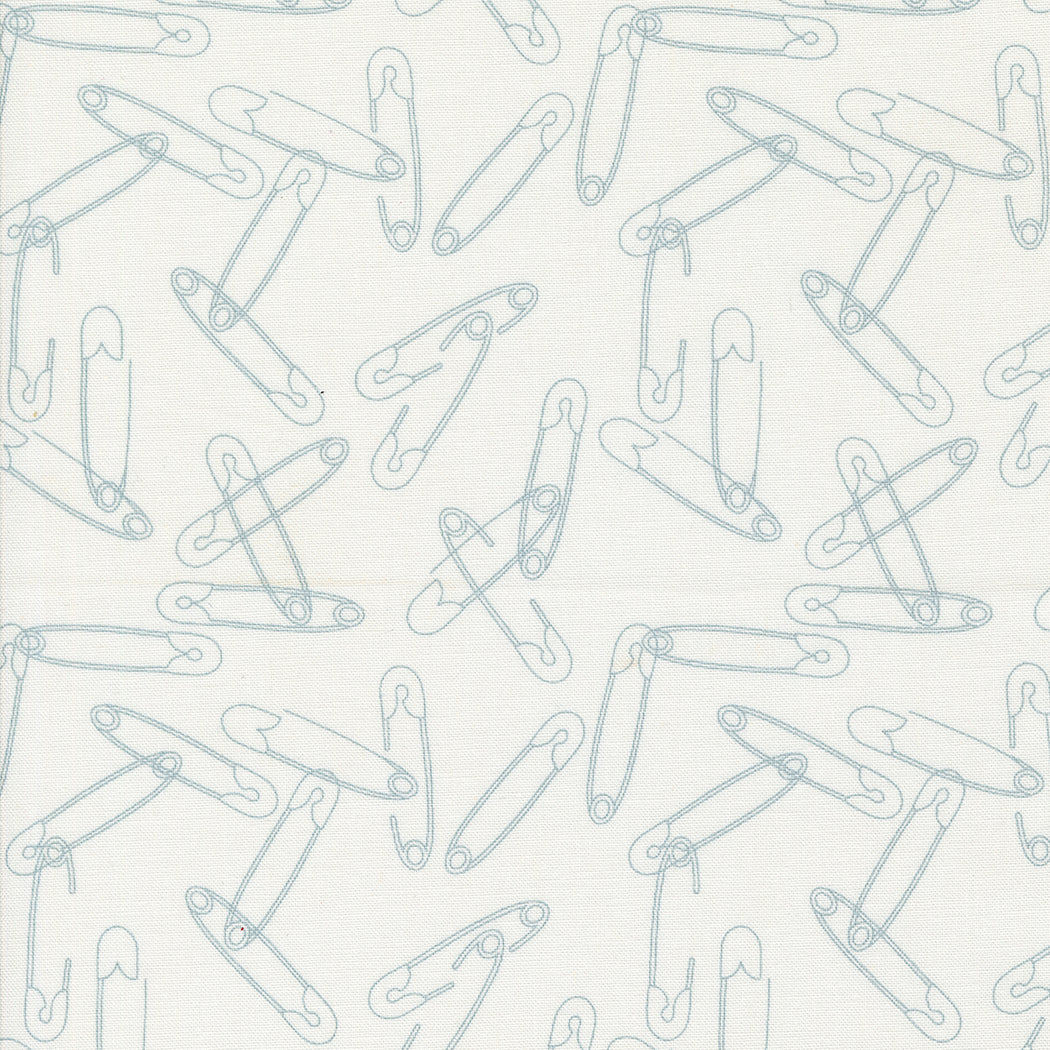 Cotton quilting fabric pattern called 'Safety Pins in White'. Part of the 'Still More Paper' fabric collection. Designed by Zen Chic for fabric company MODA. SKU: -9555. 44-45 inch width.