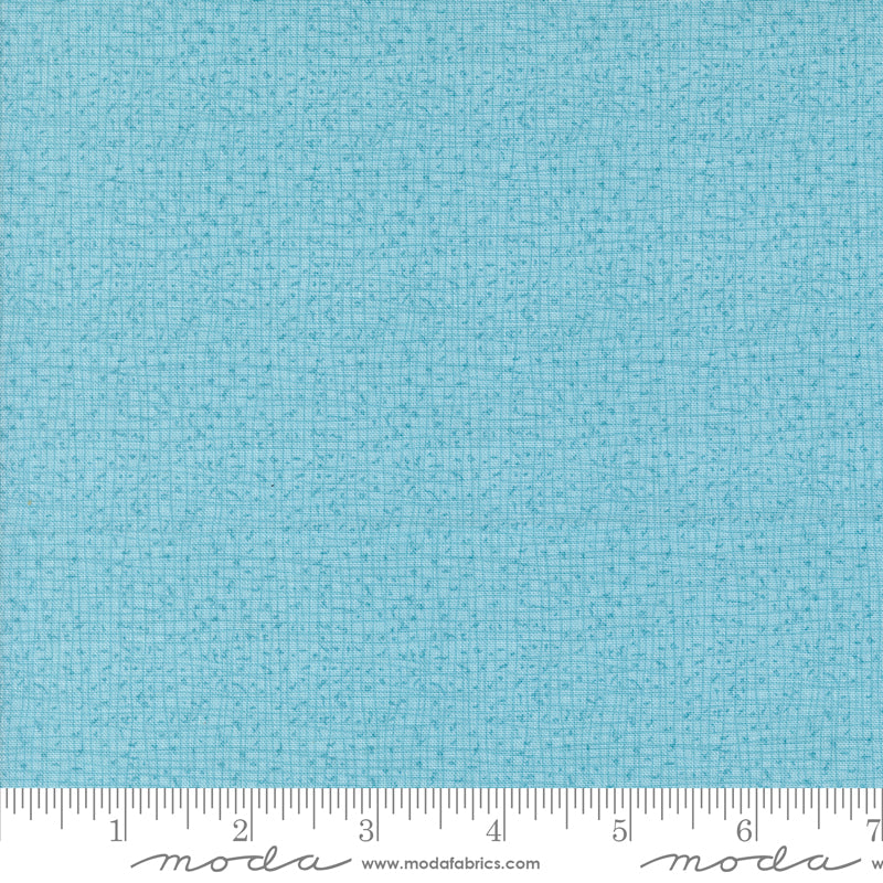 Cotton quilting fabric pattern called 'Thatched in Frost'. Part of the 'Serena Shores' fabric collection. Designed by Robin Pickens for fabric company Moda. SKU: 48626 211. 44-45 inch width.