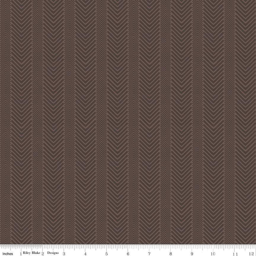 Cotton quilting fabric pattern called 'Herringbone in Brown'. Part of the 'Wake at the Lake' fabric collection. Designed by Tara Reed for fabric company Riley Blake. SKU: C14893-BROWN. 44-45 inch width.