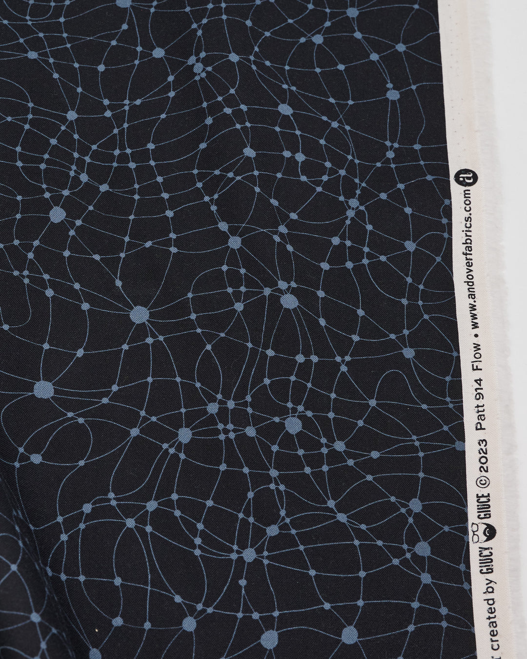 Cotton quilting fabric pattern called 'Flow in Black Widow'. Part of the 'Ink by Giucy Giuce' fabric collection. Designed by Giucy Giuce for fabric company Andover Fabrics. SKU: A-914-K. 44-45 inch width.