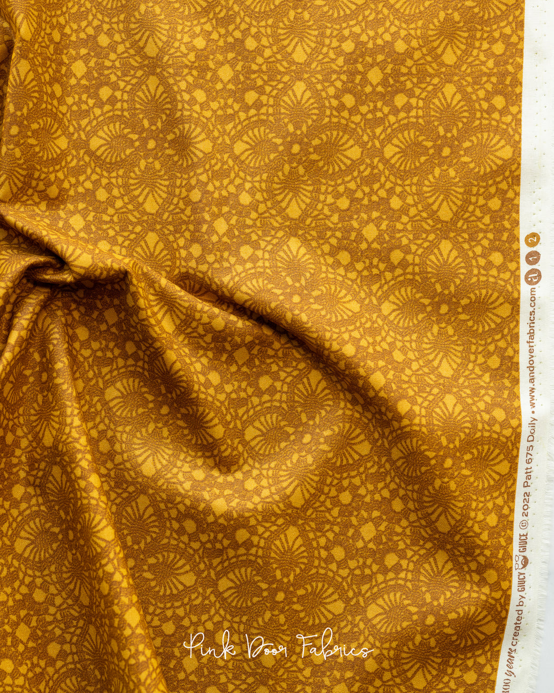 Cotton quilting fabric pattern called 'Doily in Carmello'. Part of the 'Natale' fabric collection. Designed by Giucy Giuce for fabric company Andover Fabrics. SKU: A-675-Y. 44-45 inch width.