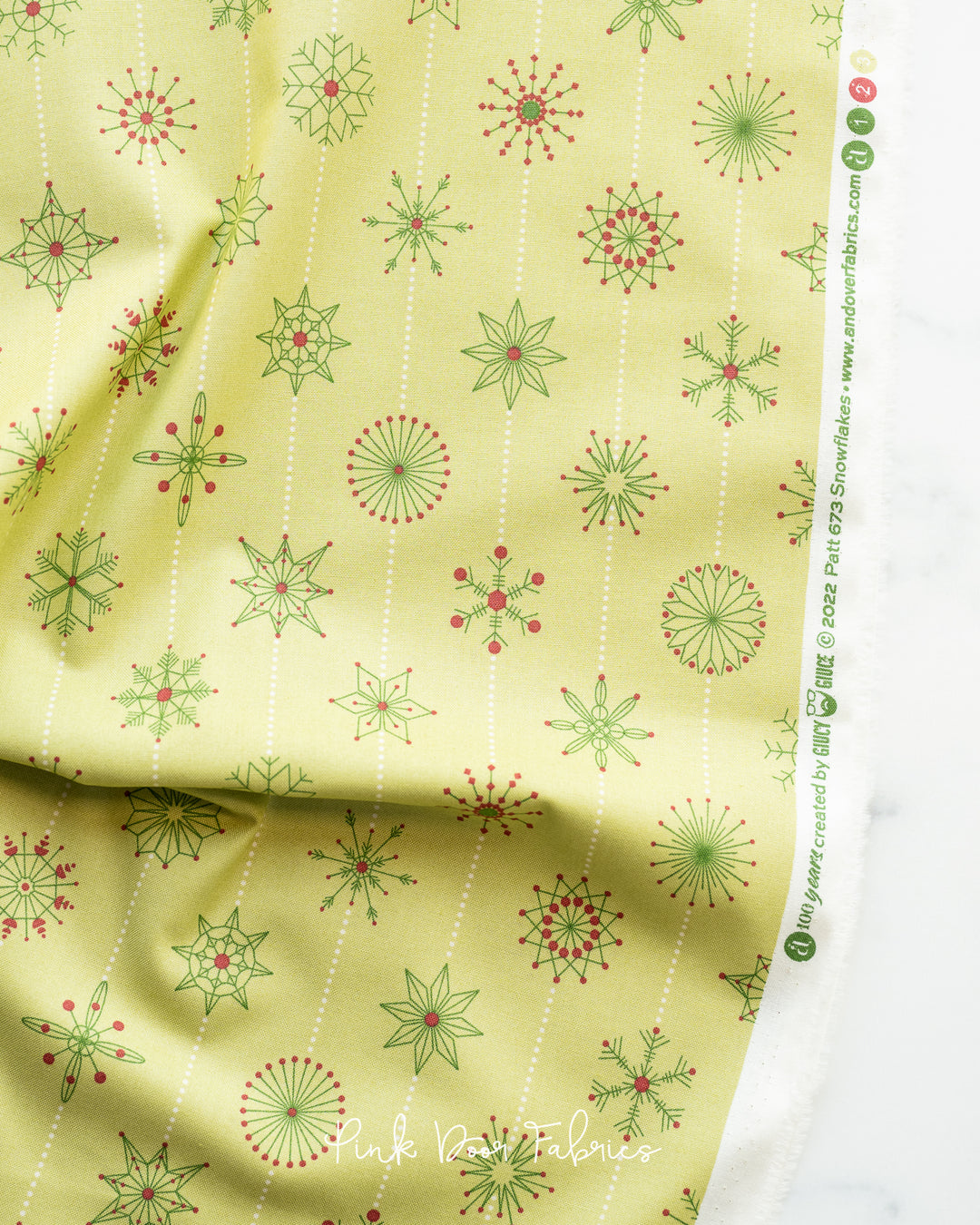 Cotton quilting fabric pattern called 'Snowflakes in Elfo'. Part of the 'Natale' fabric collection. Designed by Giucy Giuce for fabric company Andover Fabrics. SKU: A-673-LG. 44-45 inch width.