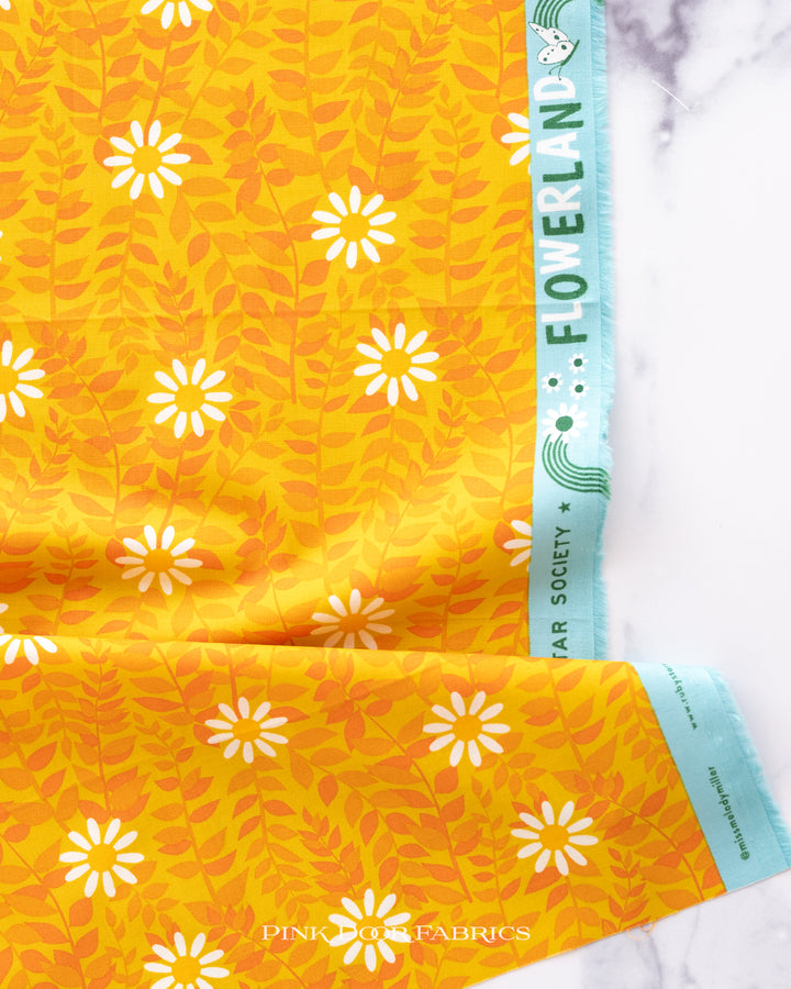 Cotton quilting fabric pattern called 'Daisies in Goldenrod'. Part of the 'Flowerland' fabric collection. Designed by Melody Miller of Ruby Star Society for fabric company Moda Fabrics. SKU: RS0075 11. 44-45 inch width.