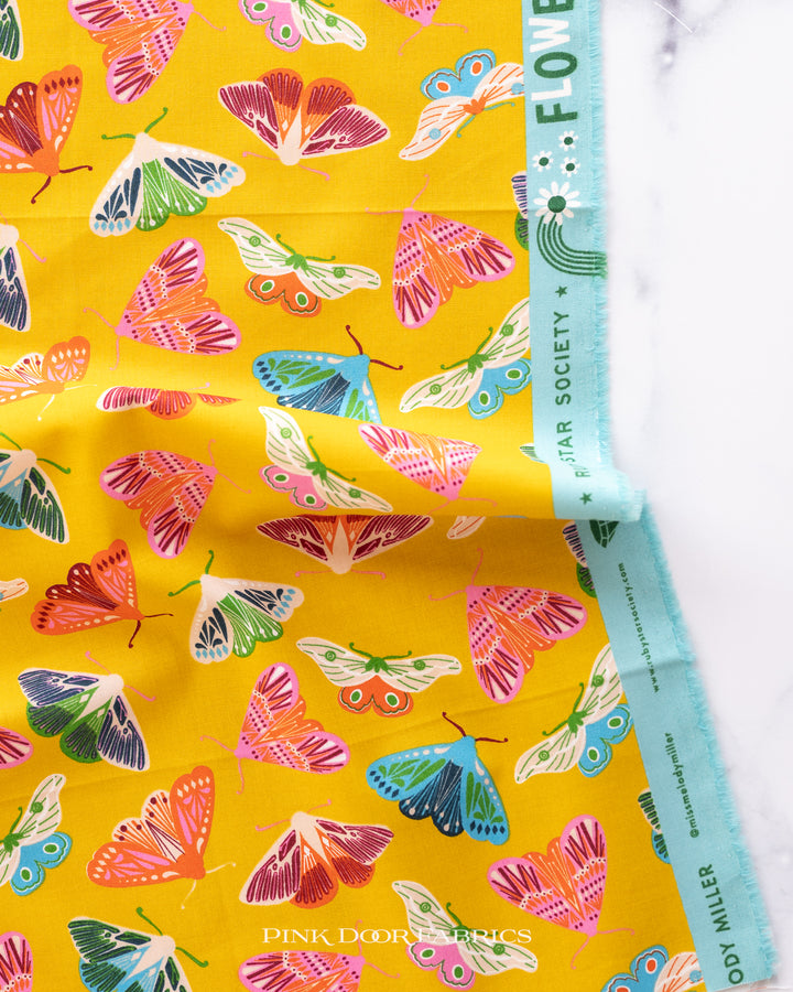 Cotton quilting fabric pattern called 'Moth in Goldenrod'. Part of the 'Flowerland' fabric collection. Designed by Melody Miller of Ruby Star Society for fabric company Moda Fabrics. SKU: RS0068 12. 44-45 inch width.