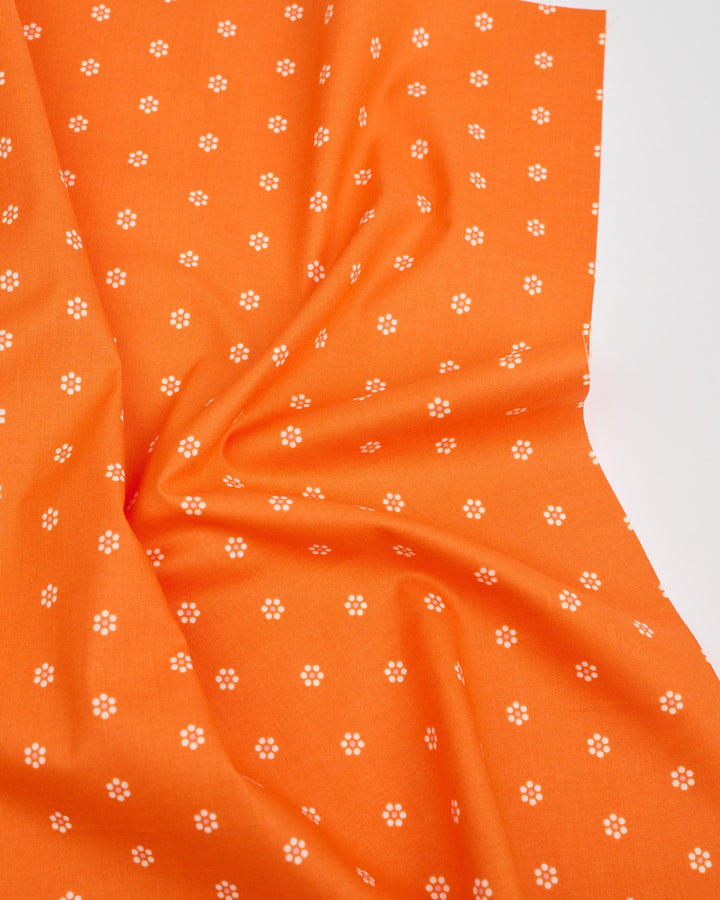 Cotton quilting fabric pattern called 'Tiny Blooms in Orange'. Part of the 'Rise and Shine' fabric collection. Designed by Melody Miller of Ruby Star Society for fabric company Moda Fabrics. SKU: RS0083 14. 44-45 inch width.