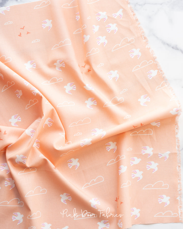 Cotton quilting fabric pattern called 'In Flight in Peach'. Part of the 'Sunbeam' fabric collection. Designed by Rashida Coleman Hale for fabric company Moda Fabrics. SKU: RS1058 14. 44-45 inch width.