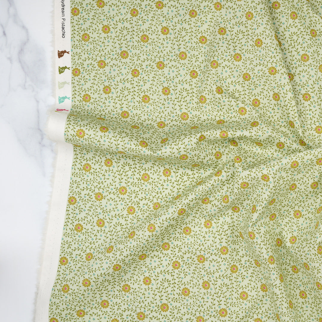 Cotton quilting fabric pattern called 'Daisydream Pistachio'. Part of the 'Sanctuary' fabric collection. Designed by Tone Finnanger for fabric company Tilda Fabrics. SKU: TIL100578. 44-45 inch width.