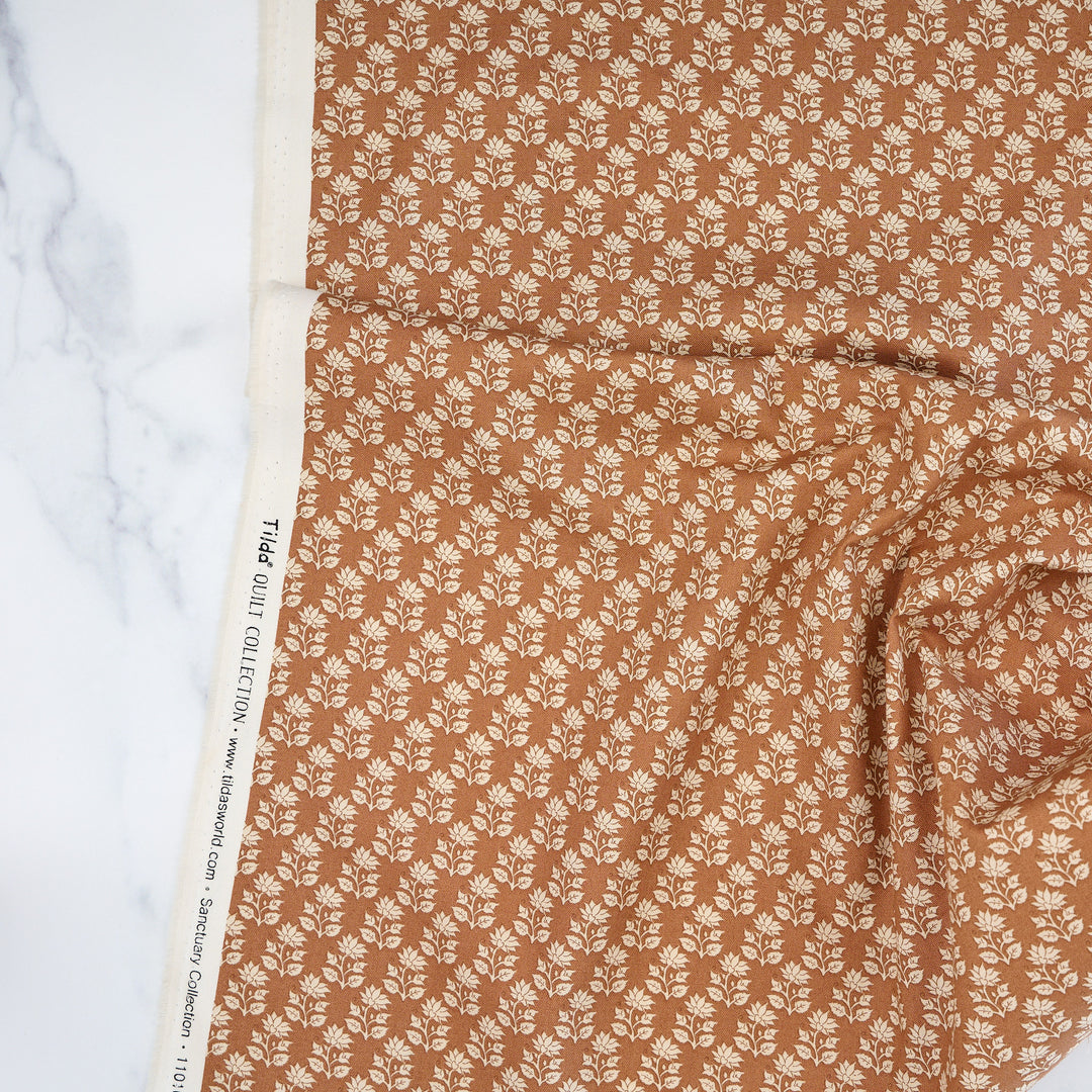 Cotton quilting fabric pattern called 'Mira Caramel'. Part of the 'Sanctuary' fabric collection. Designed by Tone Finnanger for fabric company Tilda Fabrics. SKU: TIL110107. 44-45 inch width.