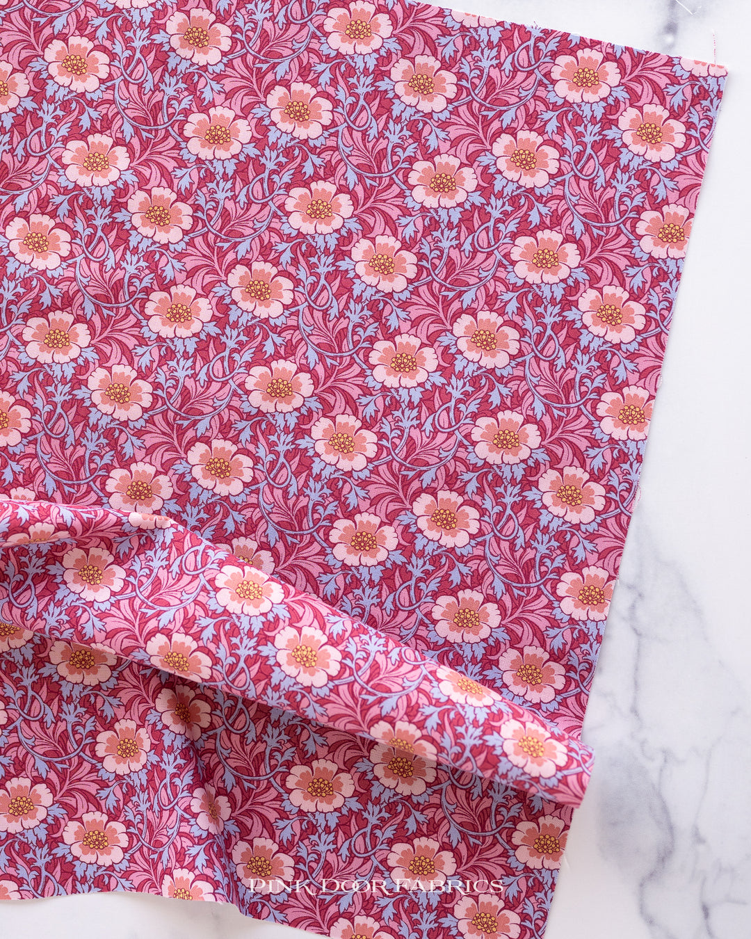 Cotton quilting fabric pattern called 'Winter Rose in Hibiscus'. Part of the 'Hibernation' fabric collection. Designed by Tilda Fabrics for fabric company Tilda Fabrics. SKU: 100527. 44-45 inch width.