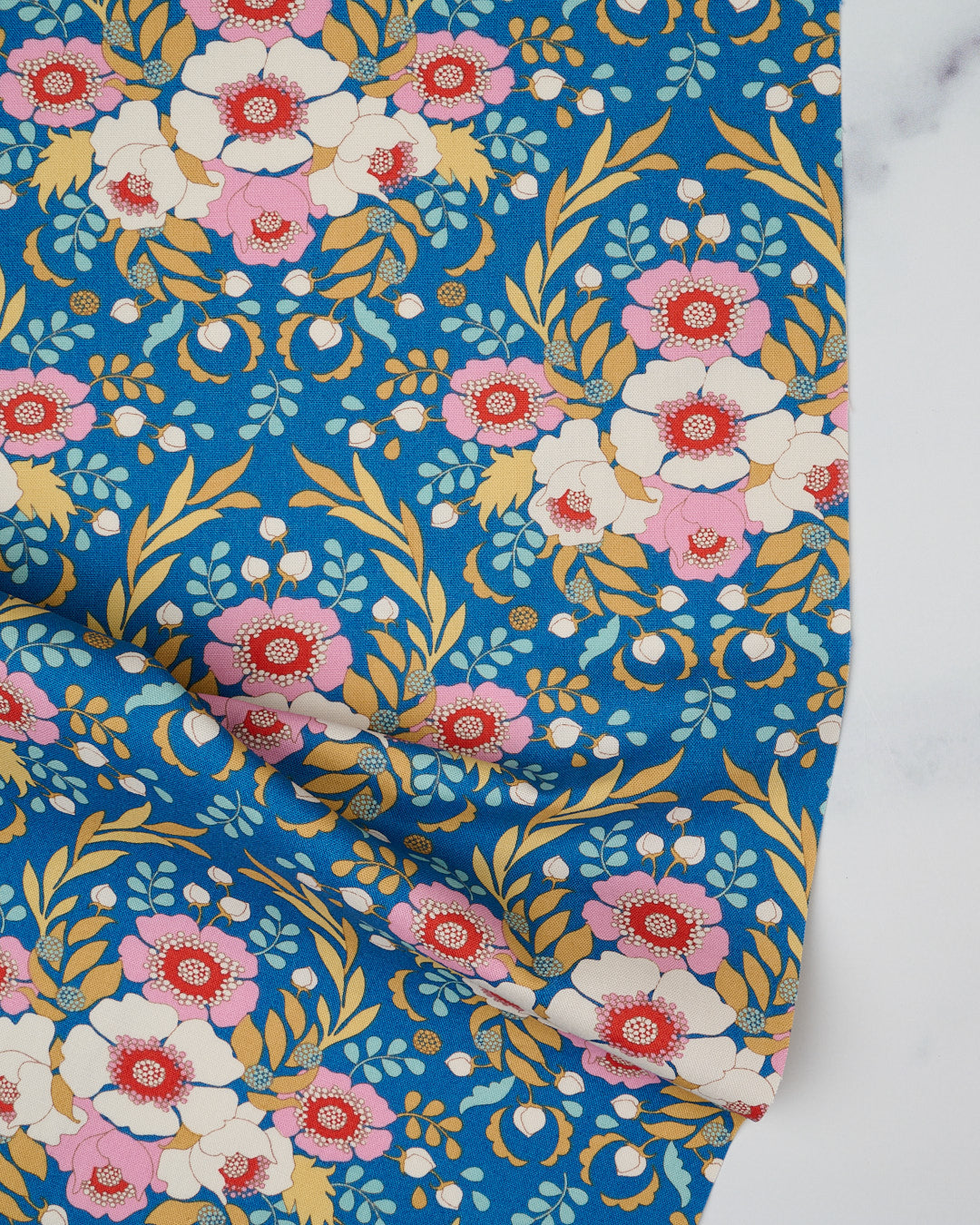 Cotton quilting fabric pattern called 'Anemone in Blue'. Part of the 'Jubilee' fabric collection. Designed by Tilda Fabrics for fabric company Tilda Fabrics. SKU: 100551. 44-45 inch width.