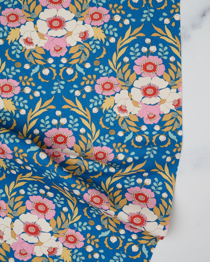 Cotton quilting fabric pattern called 'Anemone in Blue'. Part of the 'Jubilee' fabric collection. Designed by Tilda Fabrics for fabric company Tilda Fabrics. SKU: 100551. 44-45 inch width.