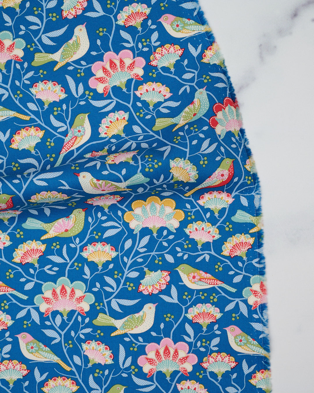 Cotton quilting fabric pattern called 'Bird Tree in Blue'. Part of the 'Jubilee' fabric collection. Designed by Tilda Fabrics for fabric company Tilda Fabrics. SKU: 100554. 44-45 inch width.