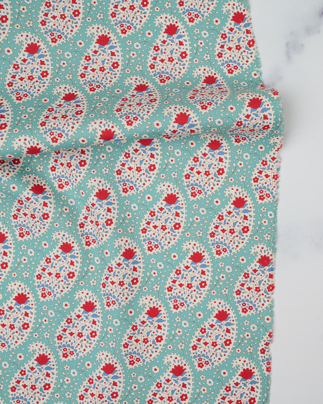 Cotton quilting fabric pattern called 'Teardrop in Teal'. Part of the 'Jubilee' fabric collection. Designed by Tilda Fabrics for fabric company Tilda Fabrics. SKU: 100556. 44-45 inch width.