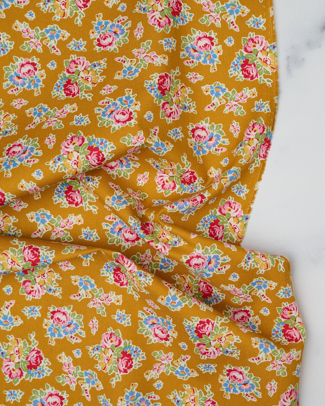 Cotton quilting fabric pattern called 'Sue in Mustard'. Part of the 'Jubilee' fabric collection. Designed by Tilda Fabrics for fabric company Tilda Fabrics. SKU: 100549. 44-45 inch width.