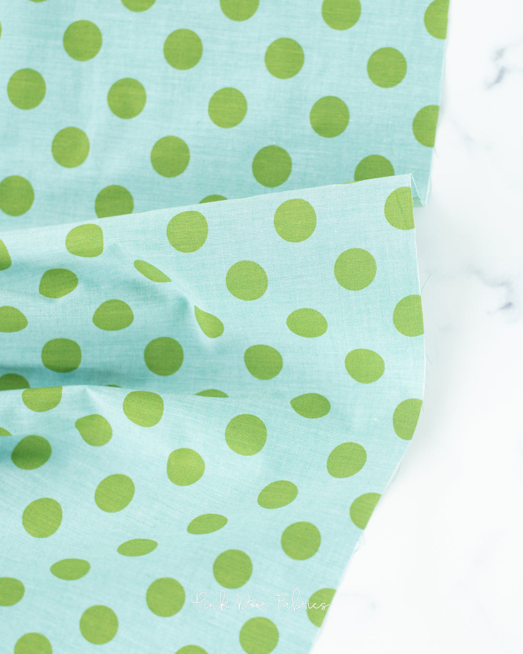 Chambray quilting fabric pattern called 'Tealgreen'. Part of the 'Chambray Dots' fabric collection. Designed by Tilda Solids for the Tilda Solids fabric company. SKU: 160059. 44-45 inch width.