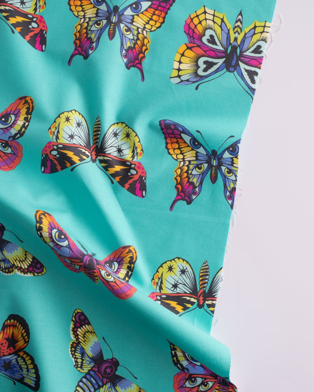 Cotton quilting fabric pattern called 'Butterfly Hugs in Lagoon'. Part of the 'Daydreamer' fabric collection. Designed by Tula Pink for fabric company Free Spirit Fabrics. SKU: PWTP171.LAGOON. 44-45 inch width.