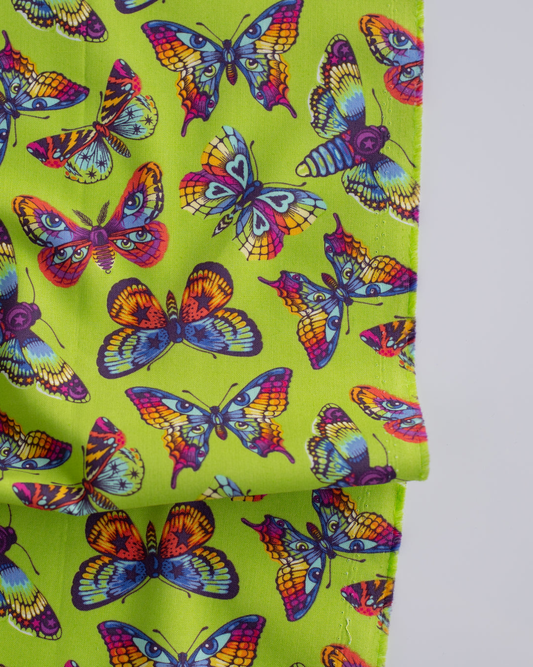 Cotton quilting fabric pattern called 'Butterfly Kisses in Avocado'. Part of the 'Daydreamer' fabric collection. Designed by Tula Pink for fabric company Free Spirit Fabrics. SKU: PWTP172.AVOCADO. 44-45 inch width.