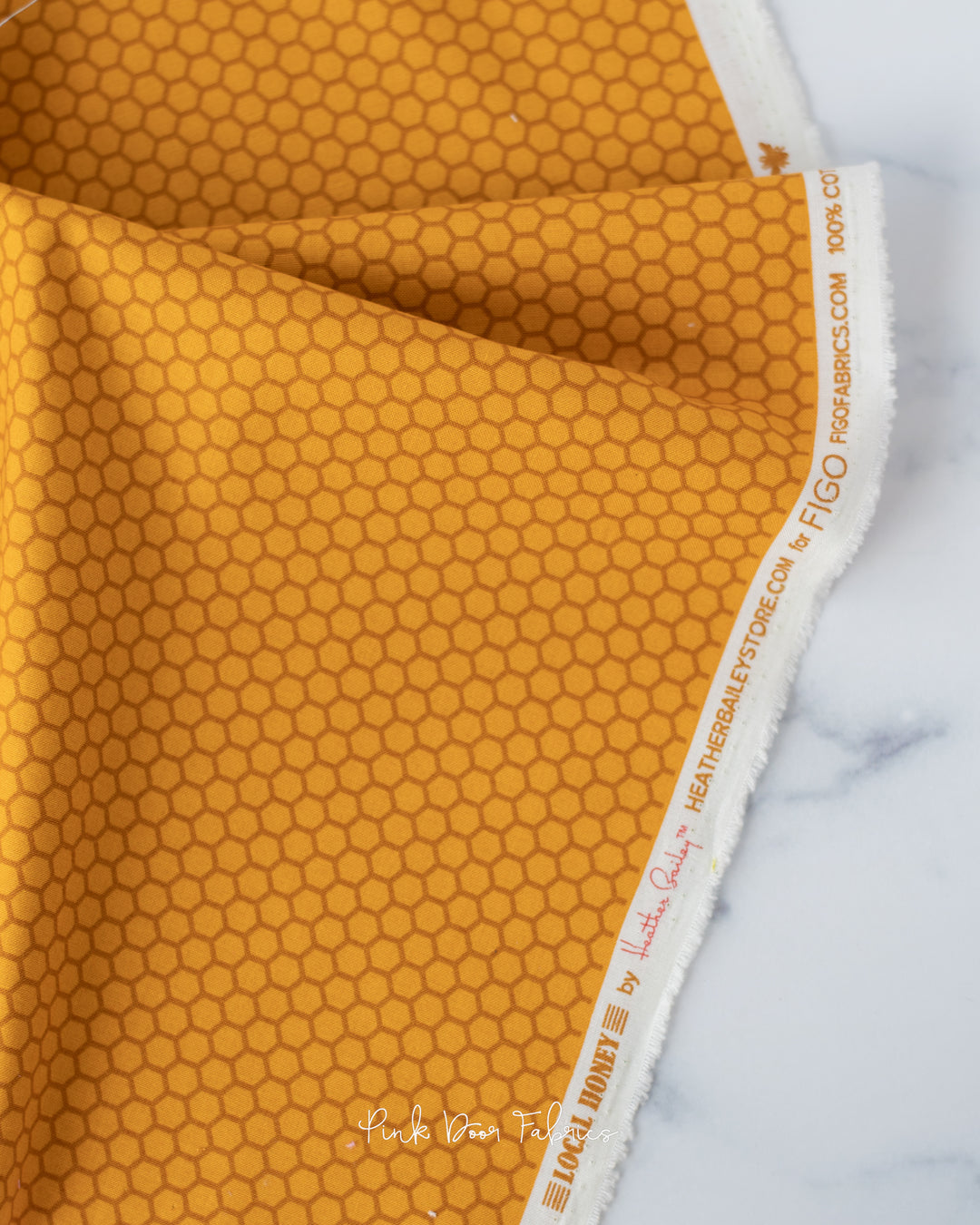 Cotton quilting fabric pattern called 'Honeycomb in Gold'. Part of the 'Local Honey' fabric collection. Designed by Heather Bailey for fabric company Figo Fabrics. SKU: 90664-55. 44-45 inch width.