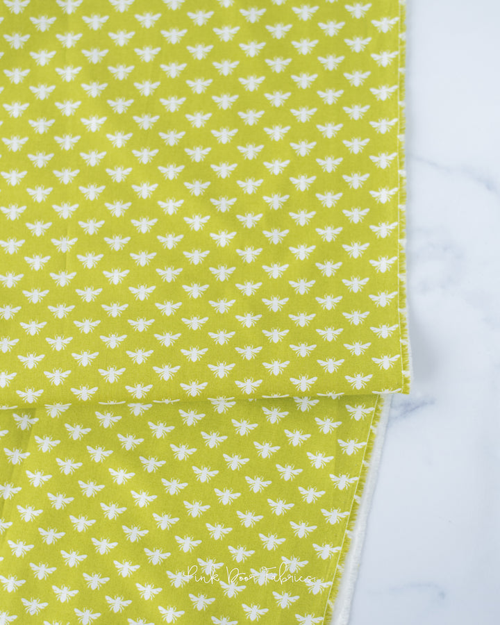 Cotton quilting fabric pattern called 'Bee Dot in Chartreuse'. Part of the 'Local Honey' fabric collection. Designed by Heather Bailey for fabric company Figo Fabrics. SKU: 90663-70. 44-45 inch width.