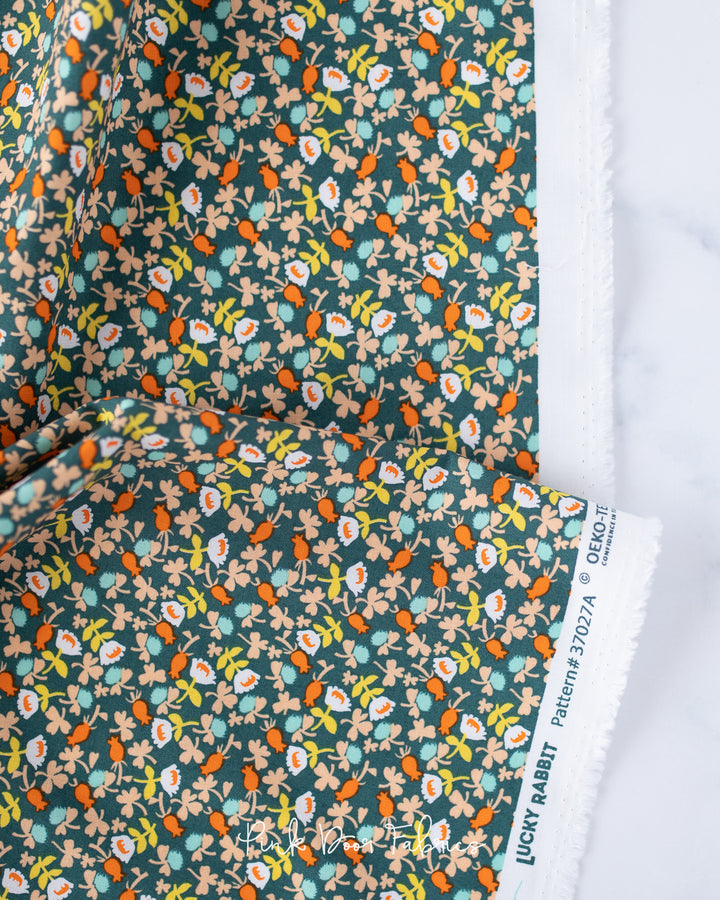 Cotton quilting fabric pattern called 'Calico in Dark Teal'. Part of the 'Lucky Rabbit' fabric collection. Designed by Heather Ross for fabric company Windham Fabrics. SKU: 37027A-10. 44-45 inch width.