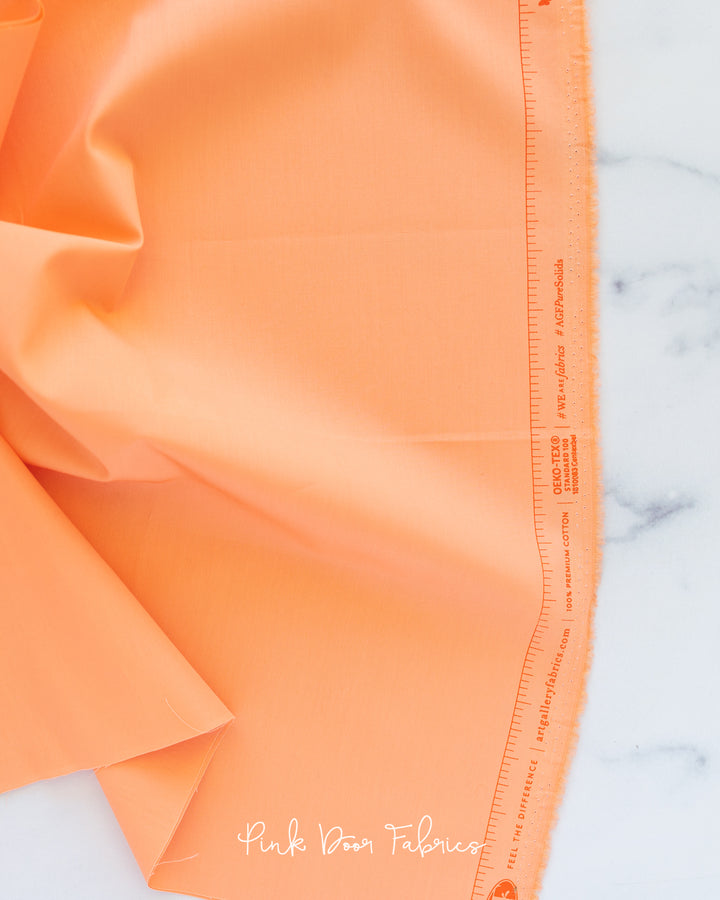 Cotton quilting fabric pattern called 'Apricot Crepe'. Part of the 'Pure Solids' fabric collection. Designed by Art Gallery Fabrics for fabric company Art Gallery Fabrics. SKU: PE-426. 44-45 inch width.